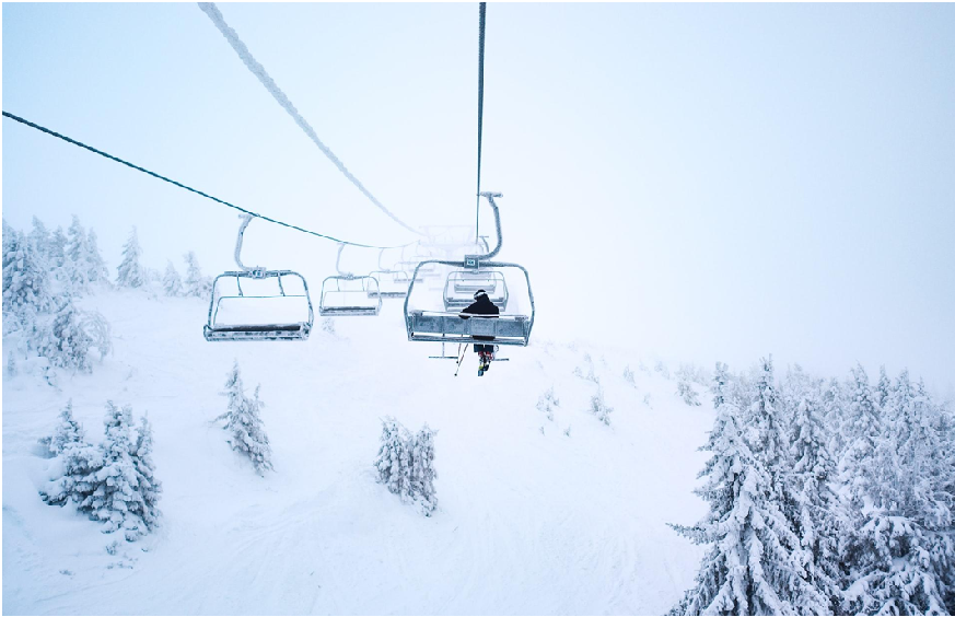 A picture of a person on a ski lift at Park City Mountain Resort, one of the places you can travel to with a Royal Holiday Vacation Club membership